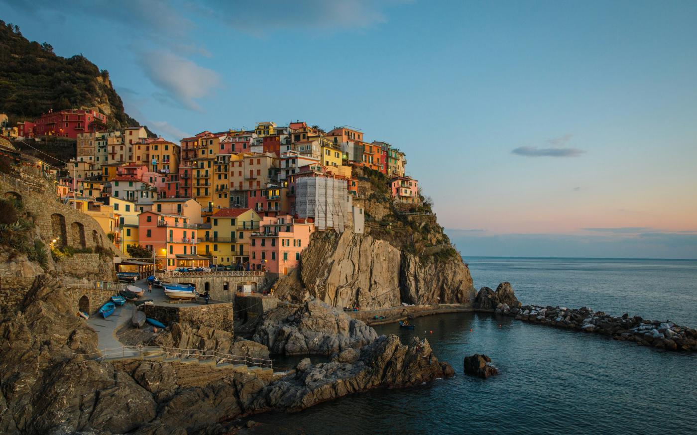 buildings near cliff under blue and white sky during daytime photography by YIFEI CHEN courtesy of Unsplash.