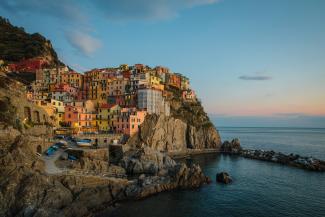 buildings near cliff under blue and white sky during daytime photography by YIFEI CHEN courtesy of Unsplash.