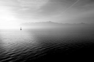 sailboat on calm body of water under white sky at daytime by Hugo Kerr courtesy of Unsplash.