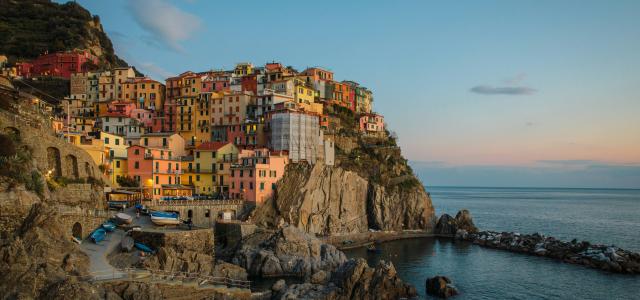 buildings near cliff under blue and white sky during daytime photography by YIFEI CHEN courtesy of Unsplash.